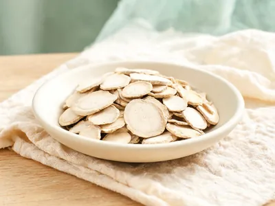 Dried processed tuber slices in a plain ceramic dish.