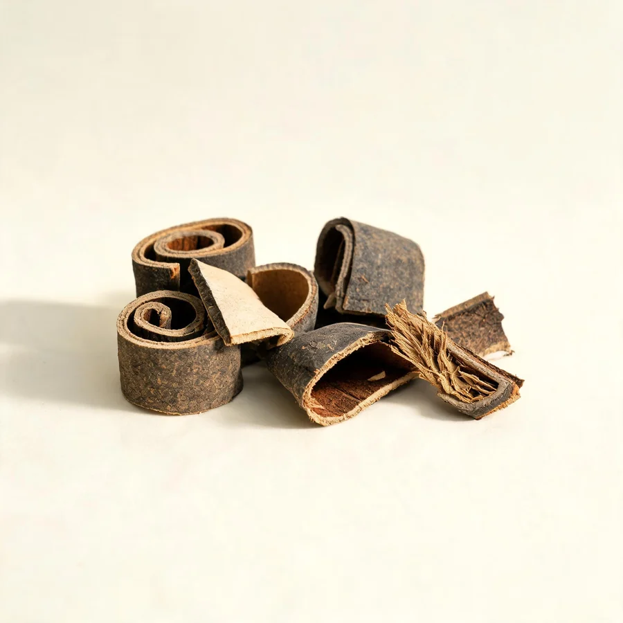 Dried Hou Po bark arranged in a shallow bowl