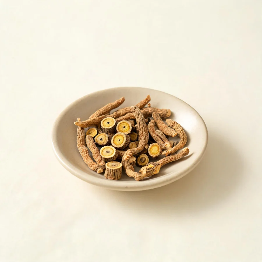 Dried Yuan Zhi root arranged in a shallow bowl